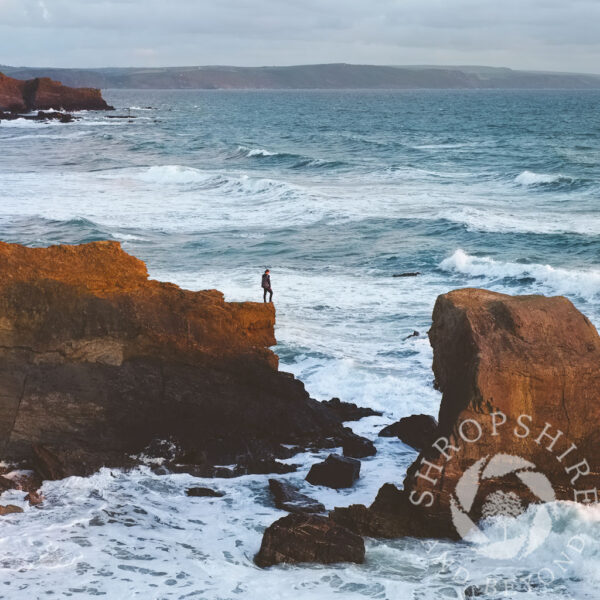 Lone figure on cliff Lone figure on cliff